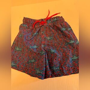 JR SWIM TRUNKS FOR BOYS. SIZE 7  BLUE & ORANGE SHARKS & FISH